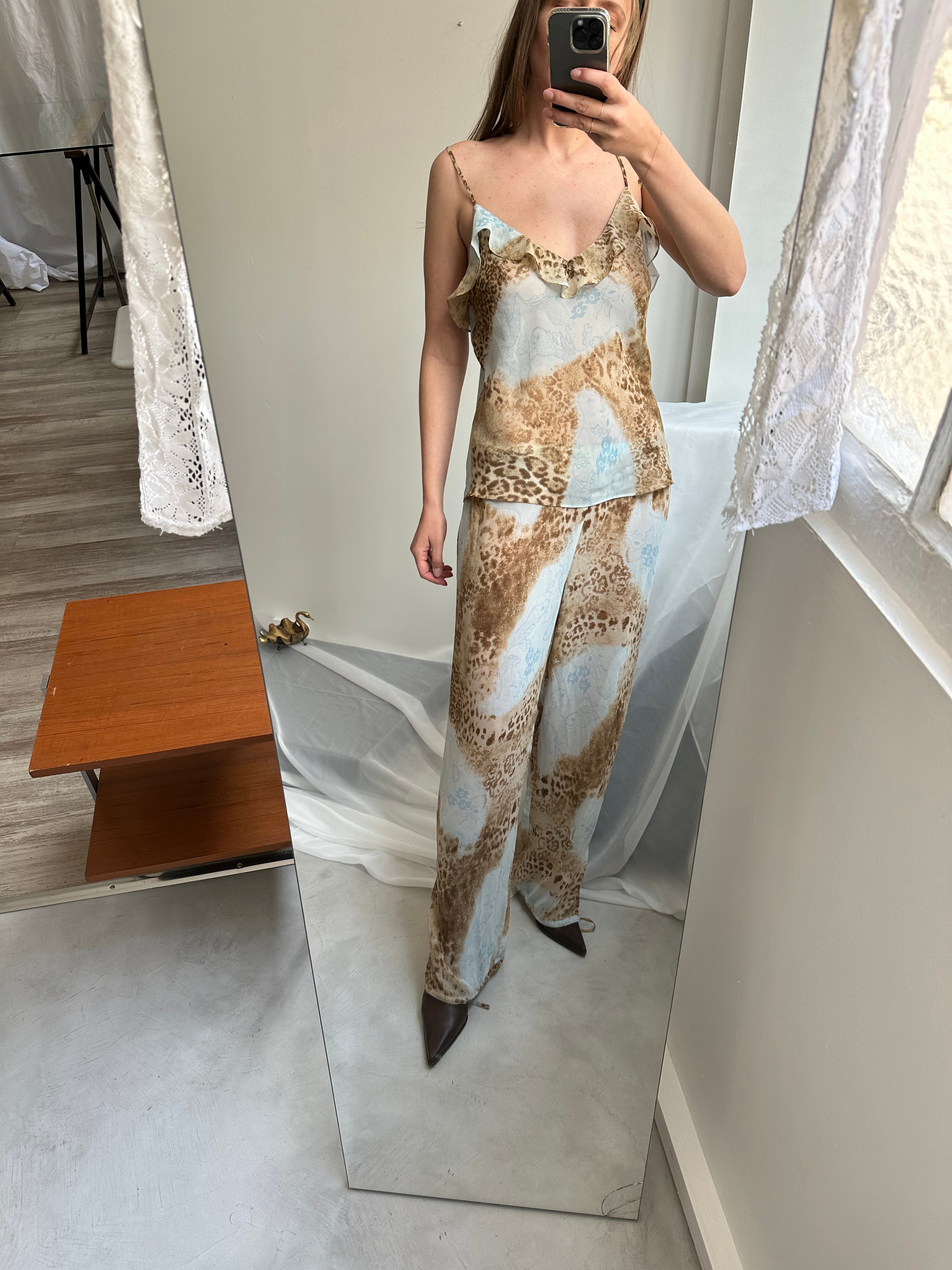 Woman taking mirror selfie wearing an eco responsible vintage leopard print set. 